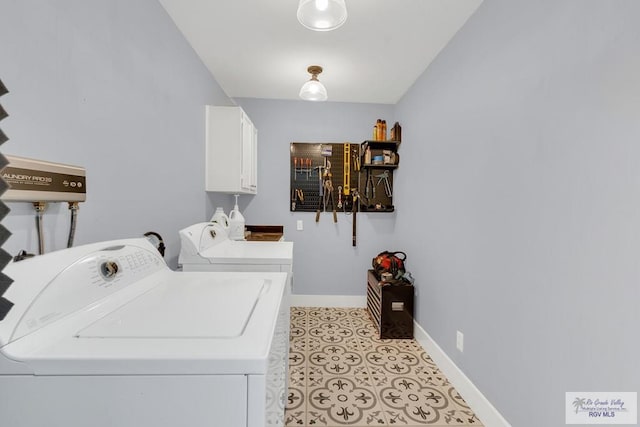 laundry area featuring cabinets and washer and clothes dryer