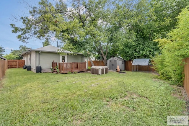 view of yard featuring a shed and a deck