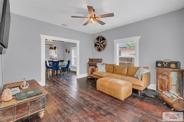 living room featuring dark hardwood / wood-style flooring and ceiling fan