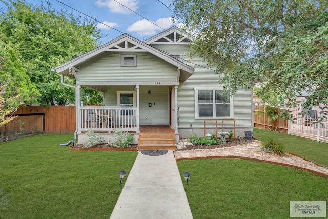 bungalow-style home featuring a porch and a front lawn