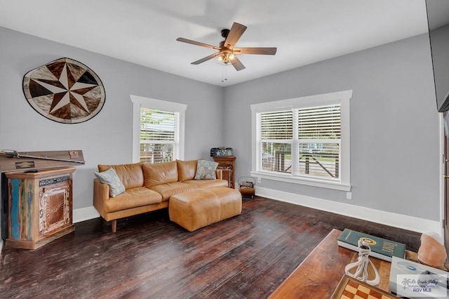 living room featuring ceiling fan and dark wood-type flooring