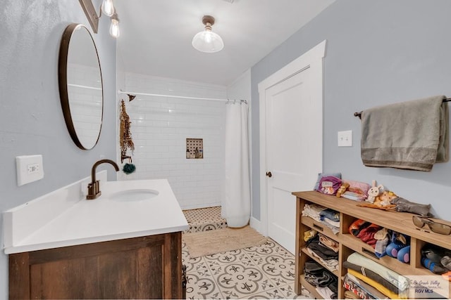 bathroom with a shower with shower curtain, vanity, and tile patterned floors