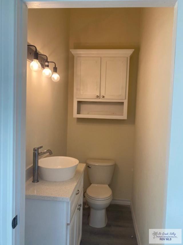 bathroom featuring hardwood / wood-style floors, vanity, and toilet