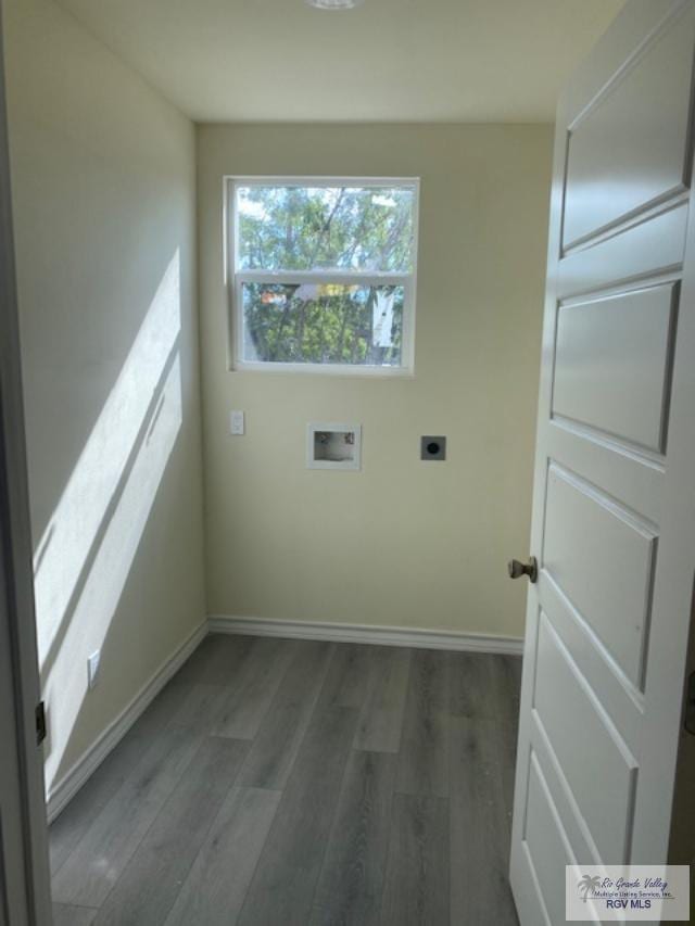 clothes washing area featuring electric dryer hookup, dark hardwood / wood-style flooring, and washer hookup