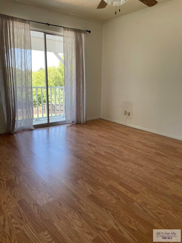 empty room with hardwood / wood-style flooring and ceiling fan