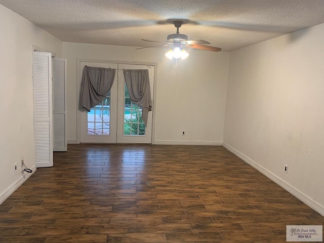 spare room with a textured ceiling, dark hardwood / wood-style floors, and ceiling fan