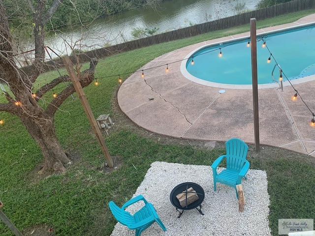 200 E Resaca Dr, Los Fresnos, TX 78566 - view of swimming pool featuring a water view, a fenced backyard, and a patio area