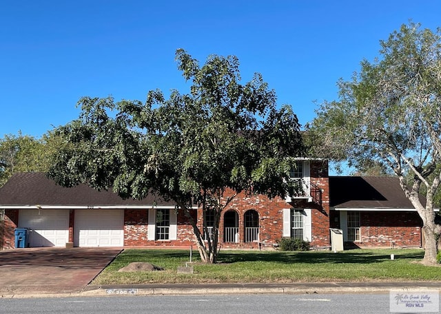 view of front of property with a garage and a front lawn