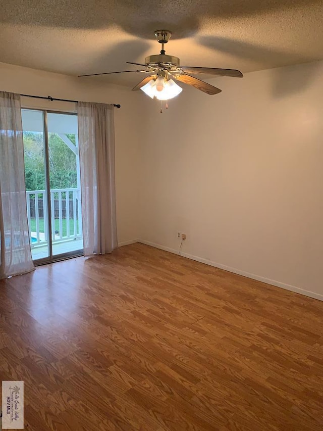 unfurnished room with ceiling fan, a textured ceiling, and wood-type flooring