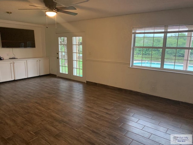 unfurnished living room featuring ceiling fan and a healthy amount of sunlight