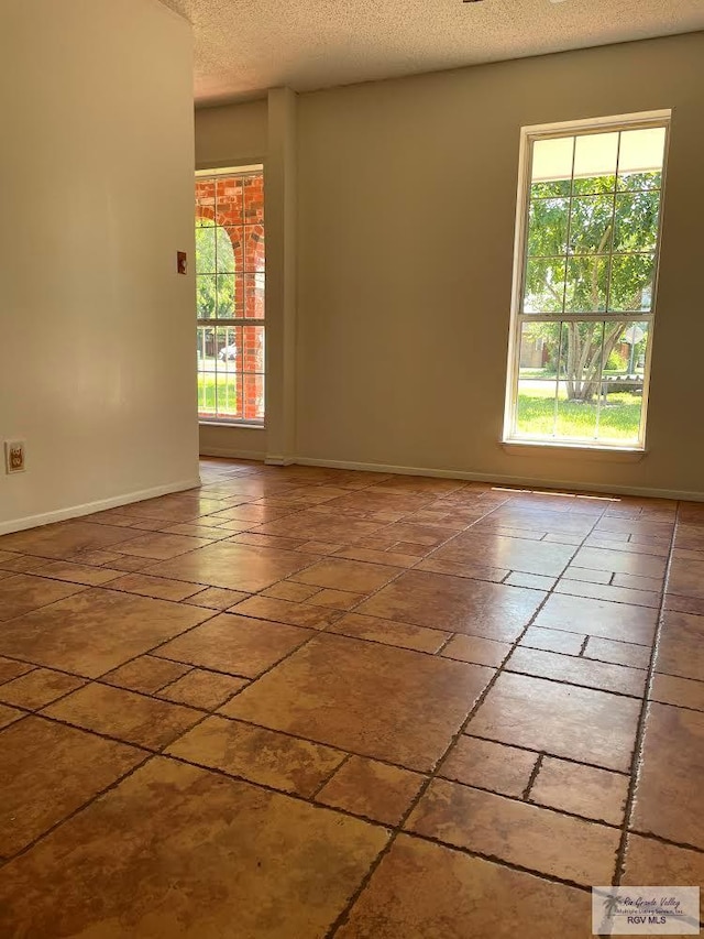 200 E Resaca Dr, Los Fresnos, TX 78566 - empty room with a textured ceiling and baseboards