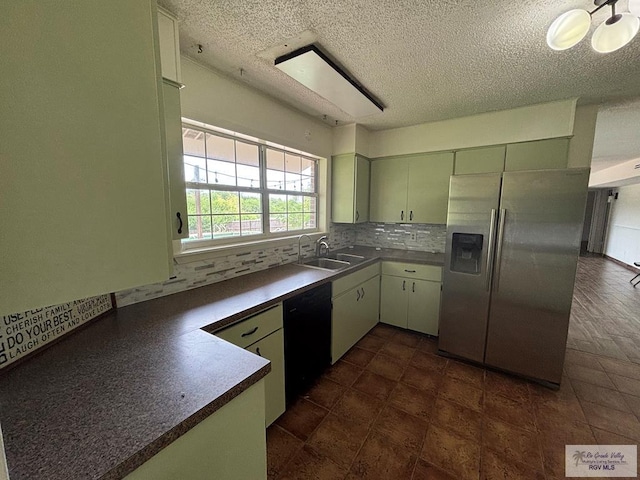 200 E Resaca Dr, Los Fresnos, TX 78566 - kitchen featuring stainless steel refrigerator with ice dispenser, dishwasher, tasteful backsplash, a textured ceiling, and dark countertops