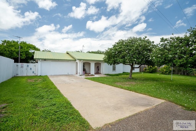 view of front of property with a front lawn and a garage