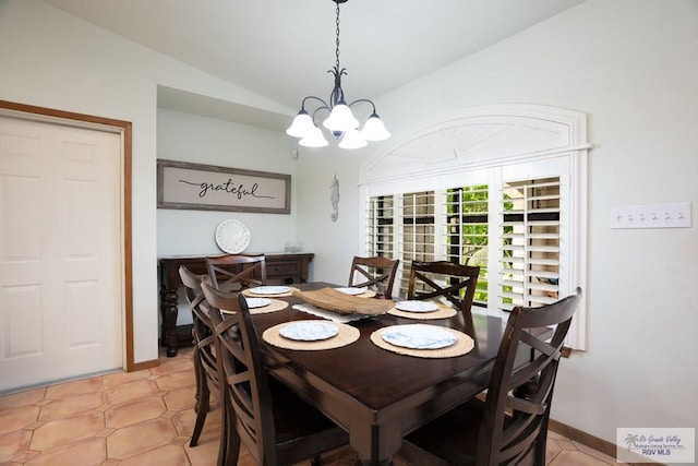 dining area with a notable chandelier, lofted ceiling, and light tile patterned floors