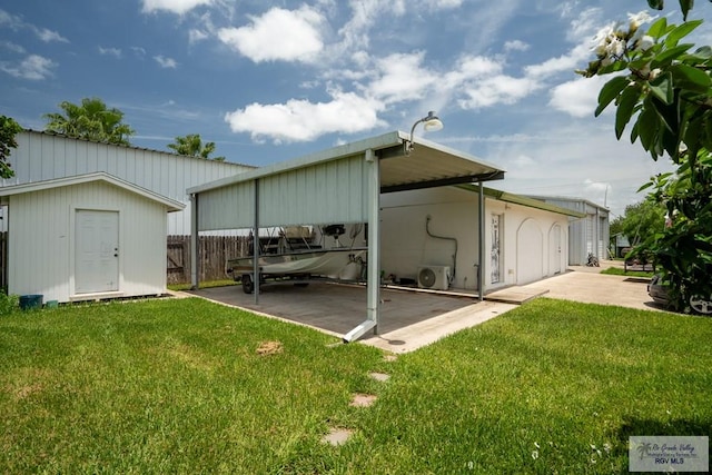 rear view of property featuring ac unit, a yard, a carport, and a storage shed