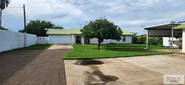 view of front of property with a carport and a front lawn