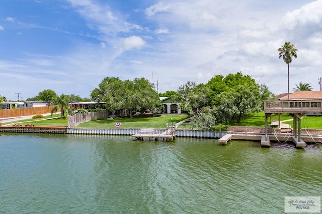 view of dock featuring a water view and a lawn