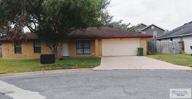 single story home featuring a garage and a front lawn