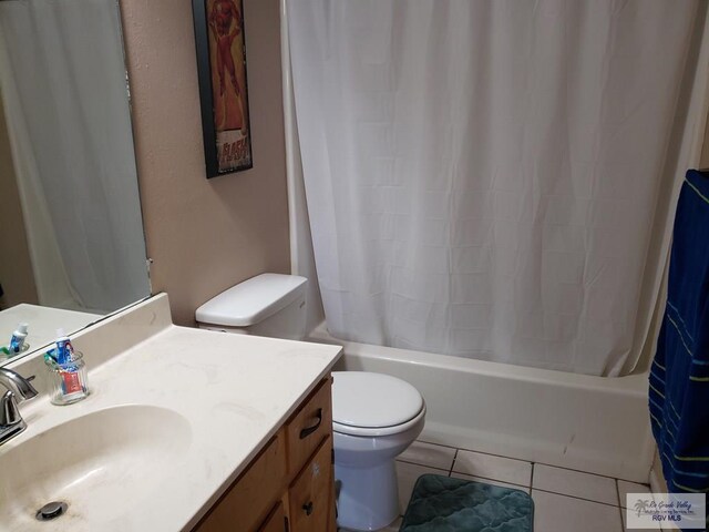 full bathroom featuring shower / bath combo with shower curtain, tile patterned flooring, vanity, and toilet