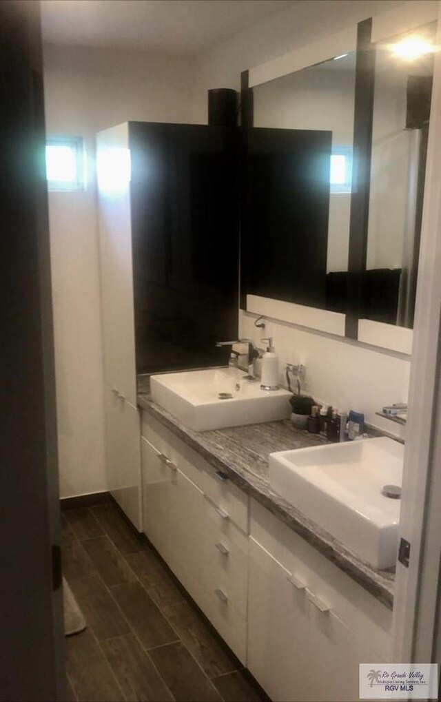 bathroom featuring hardwood / wood-style flooring and vanity