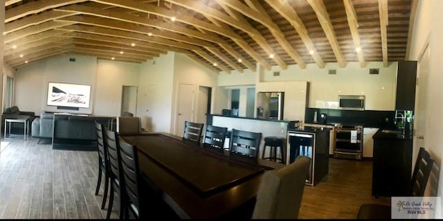 dining room featuring dark hardwood / wood-style floors, lofted ceiling, and sink