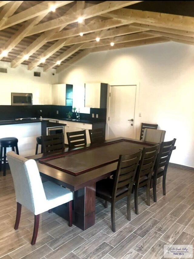 dining area featuring wood ceiling, lofted ceiling with beams, and wood-type flooring