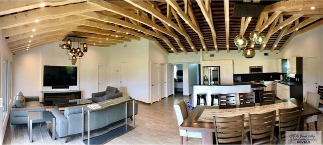 living room featuring vaulted ceiling and light hardwood / wood-style flooring