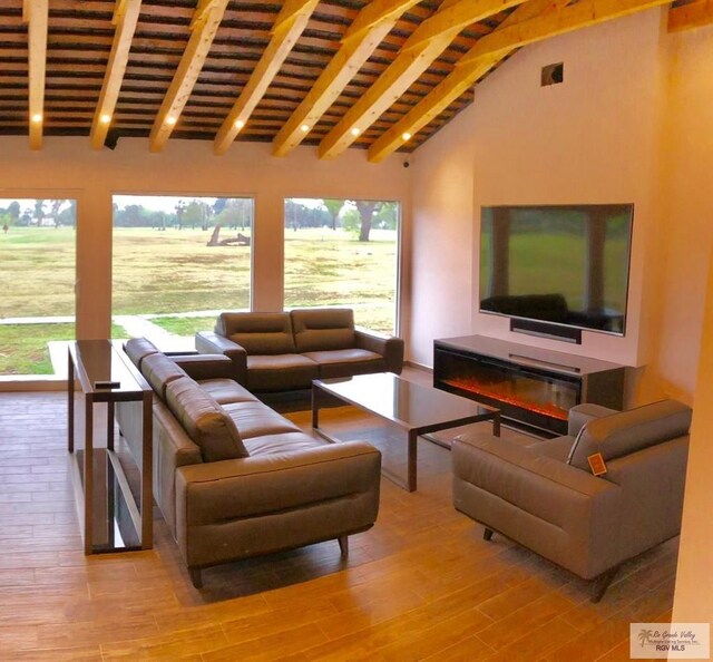 living room with lofted ceiling with beams and light wood-type flooring