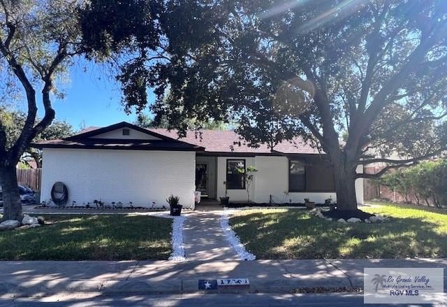 ranch-style home featuring a front yard