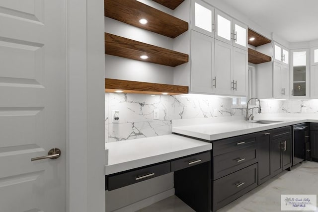 kitchen featuring backsplash, white cabinetry, and sink