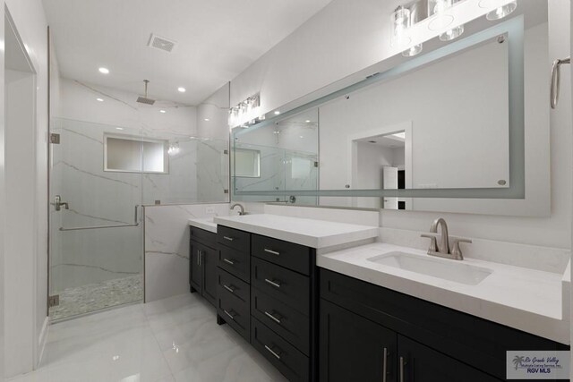 bathroom featuring vanity and a shower with shower door