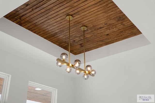 interior details featuring wooden ceiling and a chandelier