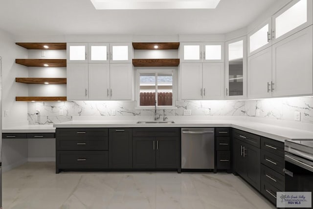 kitchen featuring white cabinets, decorative backsplash, sink, and appliances with stainless steel finishes