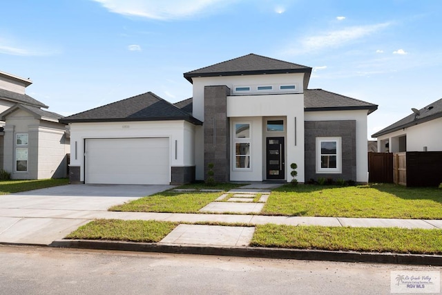 prairie-style house with a front yard and a garage