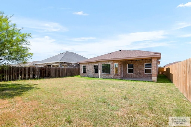 back of house featuring a lawn