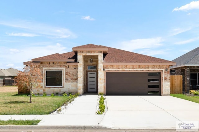 prairie-style home with a garage and a front lawn