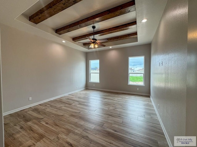 spare room featuring light wood-type flooring and ceiling fan