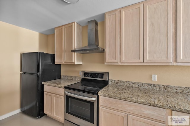 kitchen with electric range, light stone countertops, black fridge, wall chimney exhaust hood, and light brown cabinets