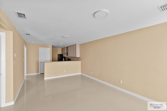 unfurnished living room featuring light tile patterned floors