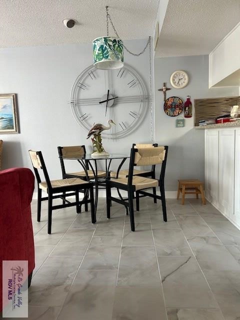 dining area featuring a textured ceiling