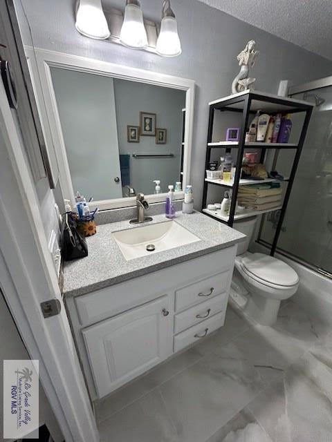 bathroom featuring walk in shower, vanity, toilet, and a textured ceiling