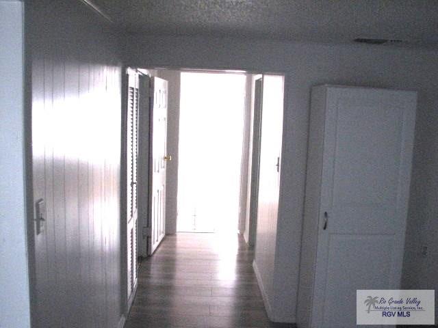 hallway featuring dark wood-style floors