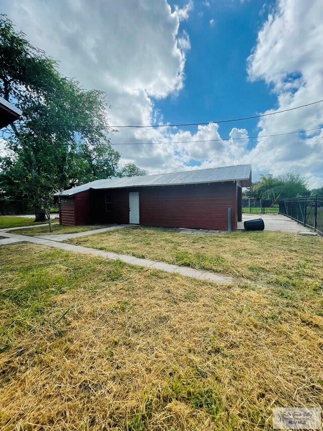 view of outbuilding featuring a yard