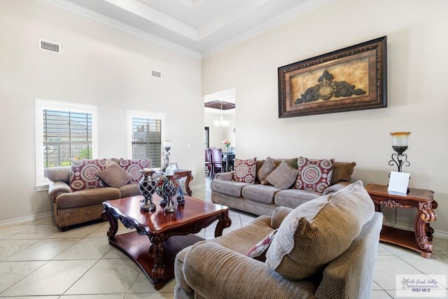 tiled living room with a high ceiling and crown molding