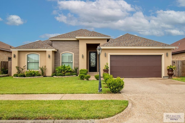 view of front of property with a garage and a front lawn