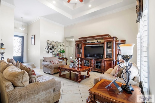 living room featuring a towering ceiling, crown molding, ceiling fan, and a healthy amount of sunlight