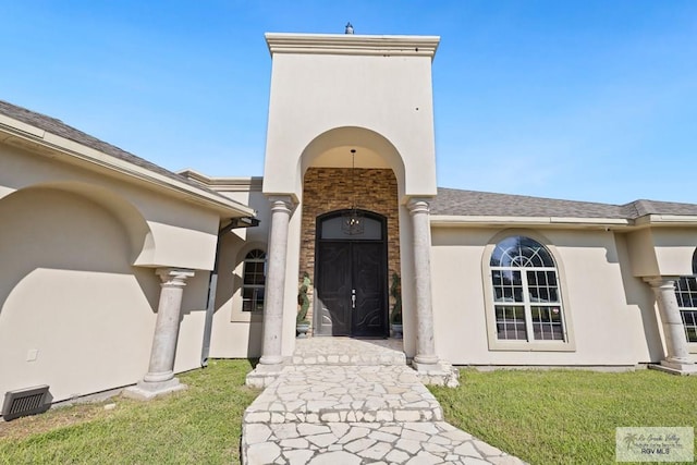 2360 Deer Run Cir, Brownsville, TX 78521 - property entrance featuring stucco siding, a lawn, and stone siding