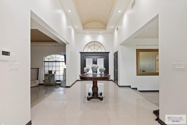 2360 Deer Run Cir, Brownsville, TX 78521 - entryway with tile patterned flooring, baseboards, a towering ceiling, a raised ceiling, and recessed lighting