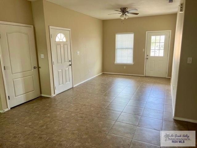 tiled entrance foyer with ceiling fan