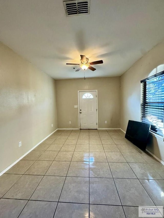 foyer featuring light tile patterned floors and ceiling fan